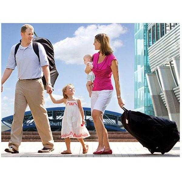Family with luggage using Britax Safe-n-Sound car seat travel bag for Toshi Baby trips