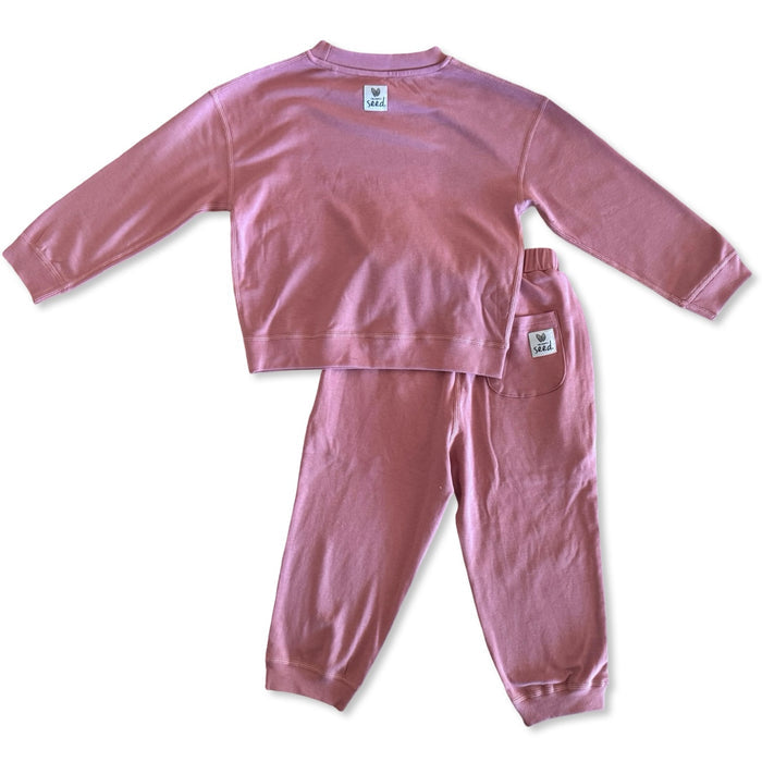 Pink children's pajama set on a white background
