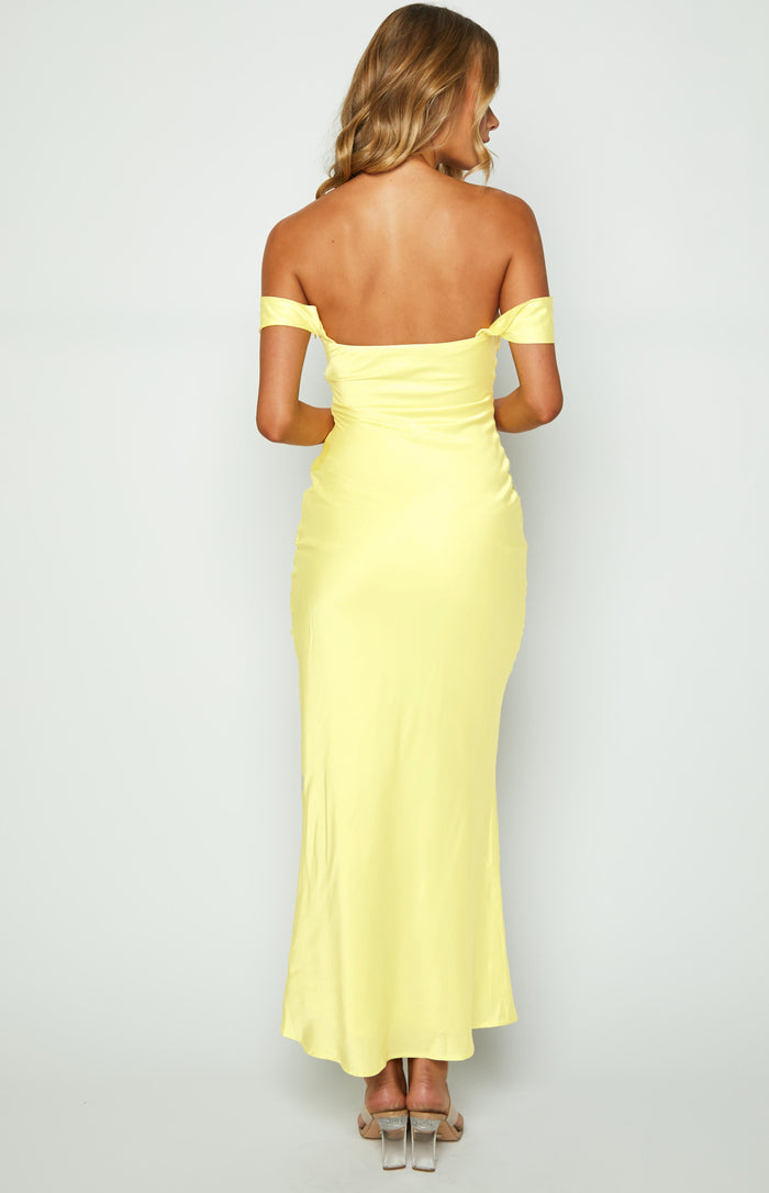 Rear view of a light yellow satin off-shoulder maxi dress with a straight back, short draped sleeves, and fitted bodice