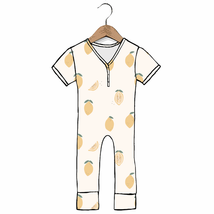 A baby short-sleeve one-piece jumpsuit with a V-neck and zipper, featuring a light beige lemon print, shown on a wooden hanger against a white background.