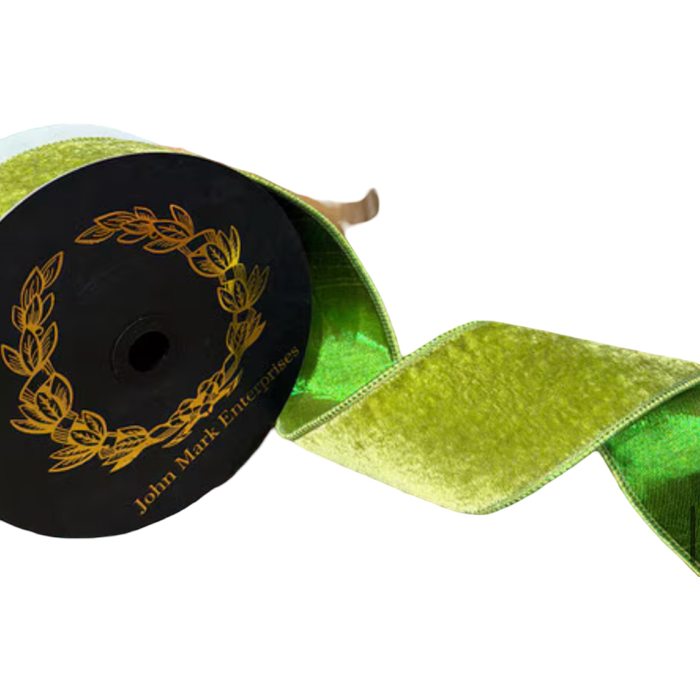 JME 2.5-inch apple green velvet ribbon curled beside a black spool, revealing its shiny green metallic dupion reverse.