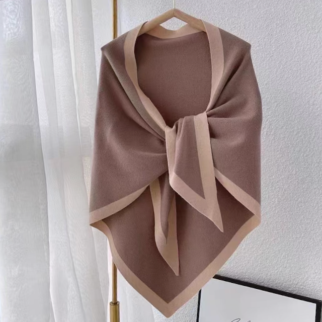 Khaki pointed hem short wrap with draped silhouette and front tie detail hanging on a wooden hanger