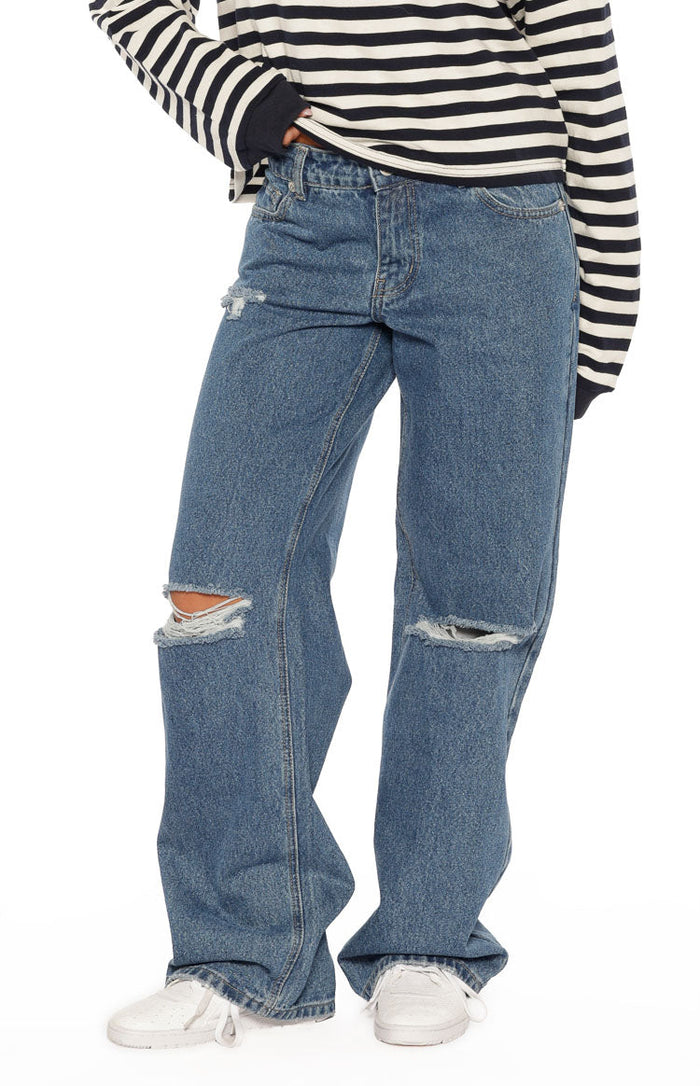 Mid wash blue denim ripped jeans with distressed knees and a relaxed straight leg fit