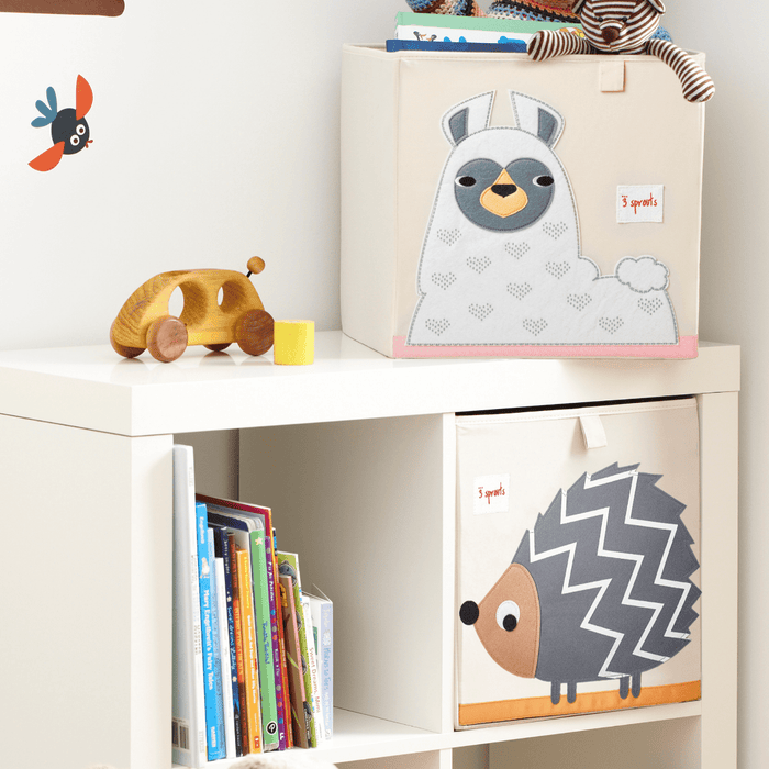Children's toy storage unit with animal-themed boxes and toys on a white shelf.
