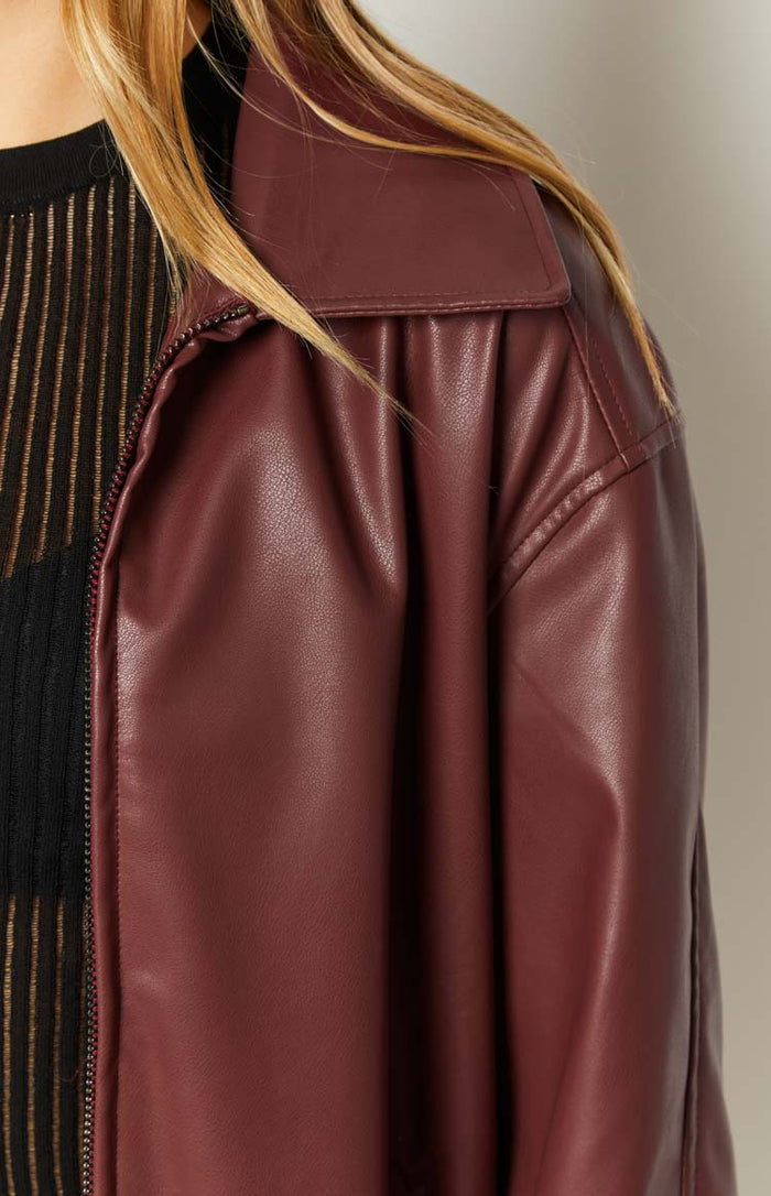 Close-up of the red PU bomber jacket's textured faux leather, wide collar, and front zipper