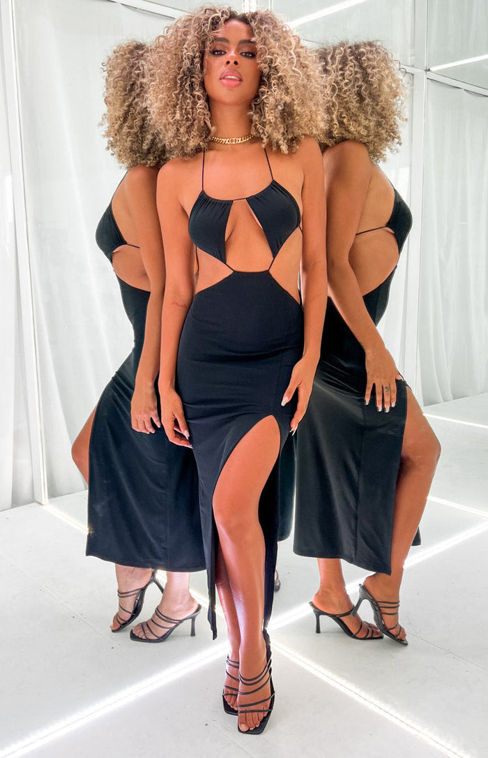 Front view of a black fitted midi dress with halter neck, triangle bust cutouts, side waist cutouts, and a high leg split