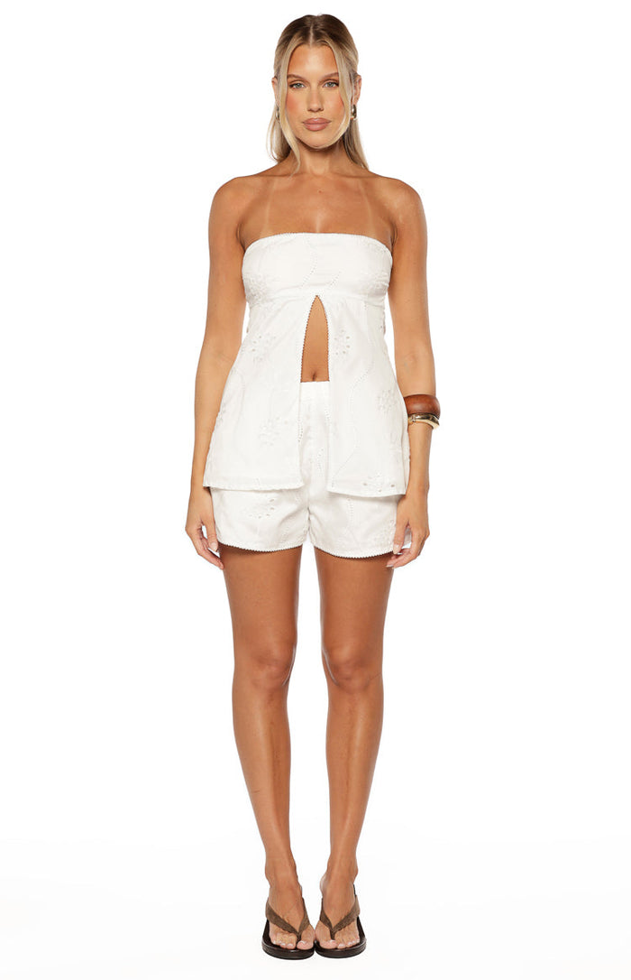 White floral eyelet strapless longline top with a split front and scalloped hem