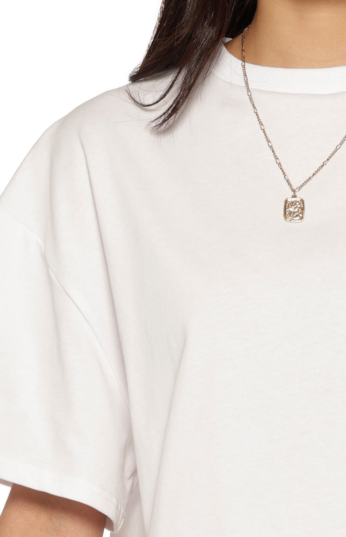Close-up of the white cotton jersey tee showing the ribbed crew neck and short sleeve hem