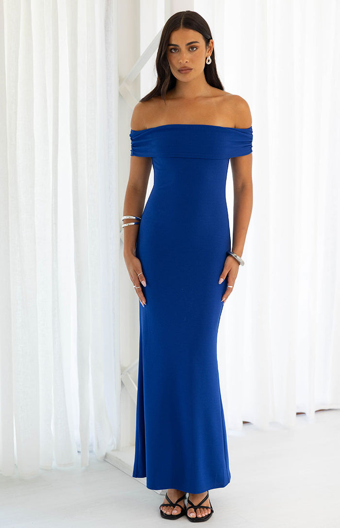 Cobalt blue crepe maxi dress with an off-shoulder neckline and ruched short sleeves