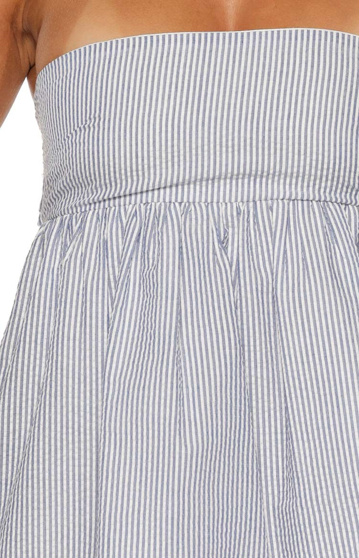 Close-up of the blue and white seersucker stripe mini dress, showing the strapless bodice and gathered waistline