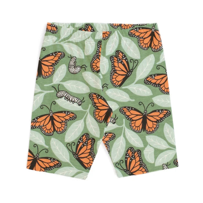 Shorts with orange butterfly pattern on a green background