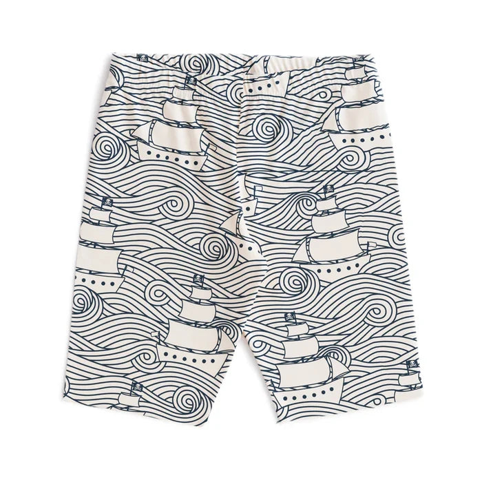 Shorts with navy sailboat and wave pattern on a white background