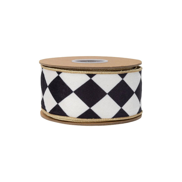 Checkered ribbon with black and white pattern on a wooden spool against a white background