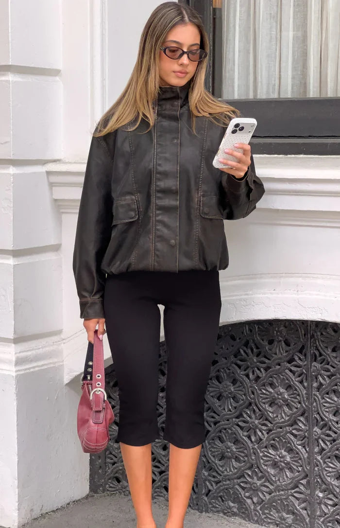 Front view of a brown PU funnel neck jacket with chest flap pockets and an elasticated blouson hem