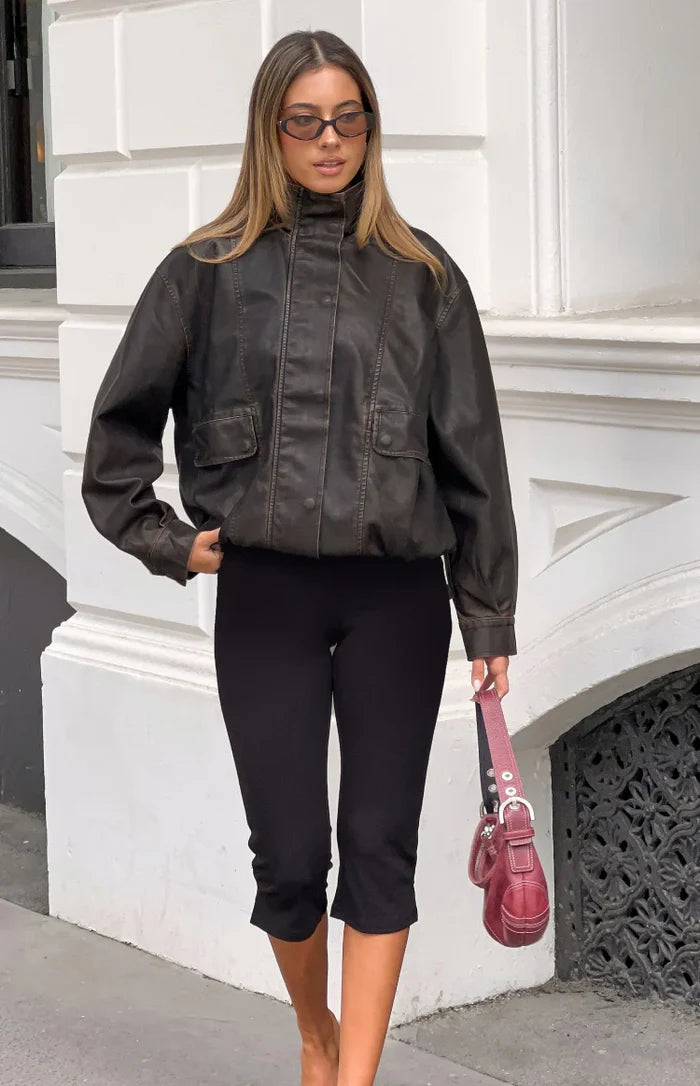 Front view of a distressed brown PU jacket with a funnel neck, button placket, and elasticated hem