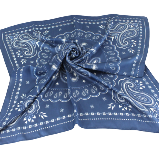 A square blue bandana scarf with a white paisley pattern, styled in a central swirl on a plain white background.