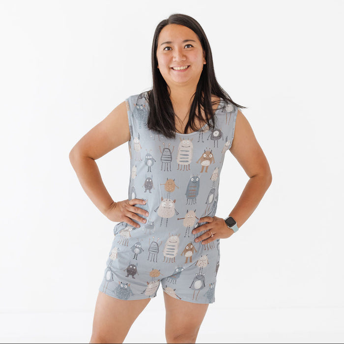 Woman wearing a sleeveless romper with cartoon character pattern on a white background