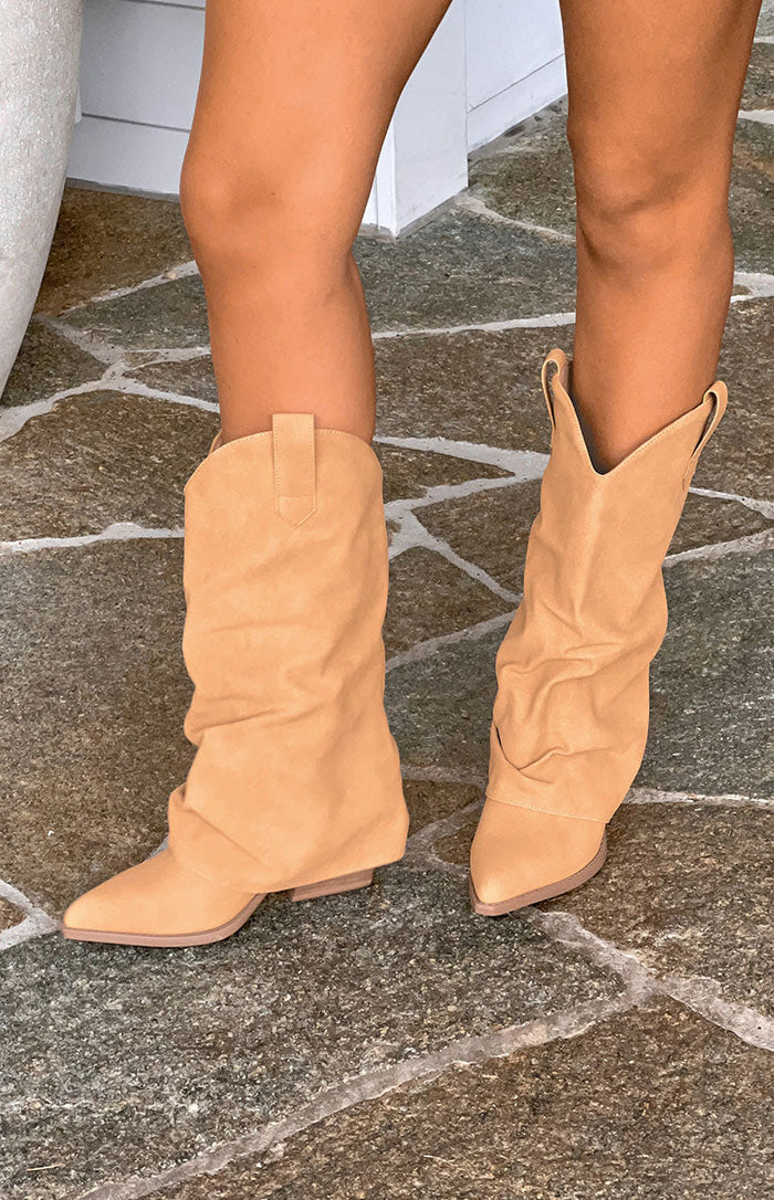 Tan suedette foldover boots with a slouchy shaft, pointed toe, and V-cut top