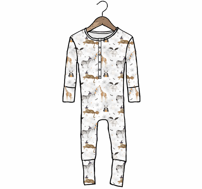 A long-sleeve baby jumpsuit with an allover safari animal print, hanging on a wooden hanger against a plain white background.