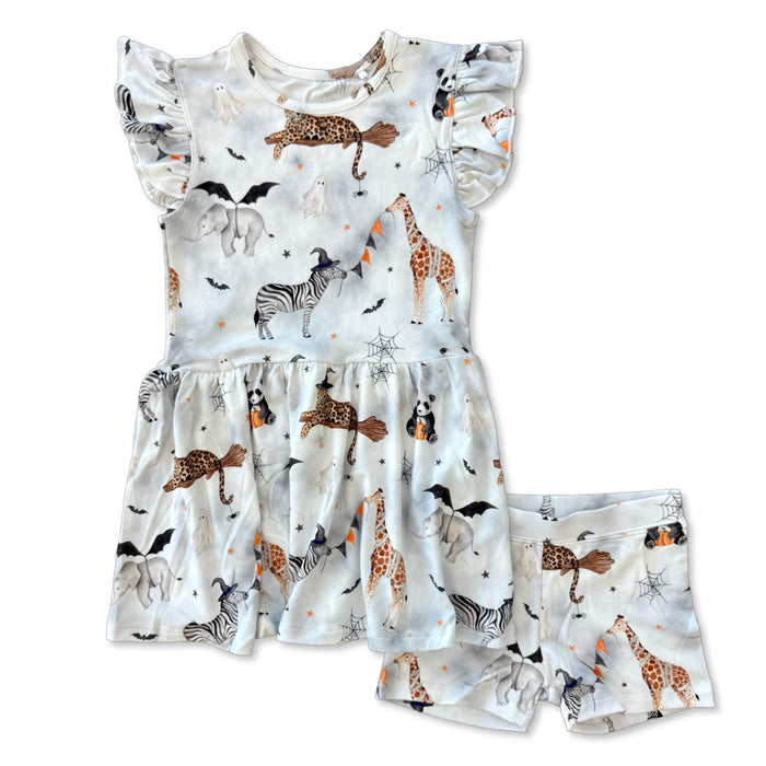 A baby girl's two-piece romper and shorts set featuring a whimsical safari animal print with zebras, giraffes, lions, bats, and stars on a white background.