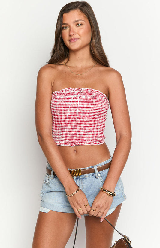 Beginning Boutique Boston Red Gingham Strapless Top red and white gingham smocked strapless crop top with ruffled trim and front tie detail