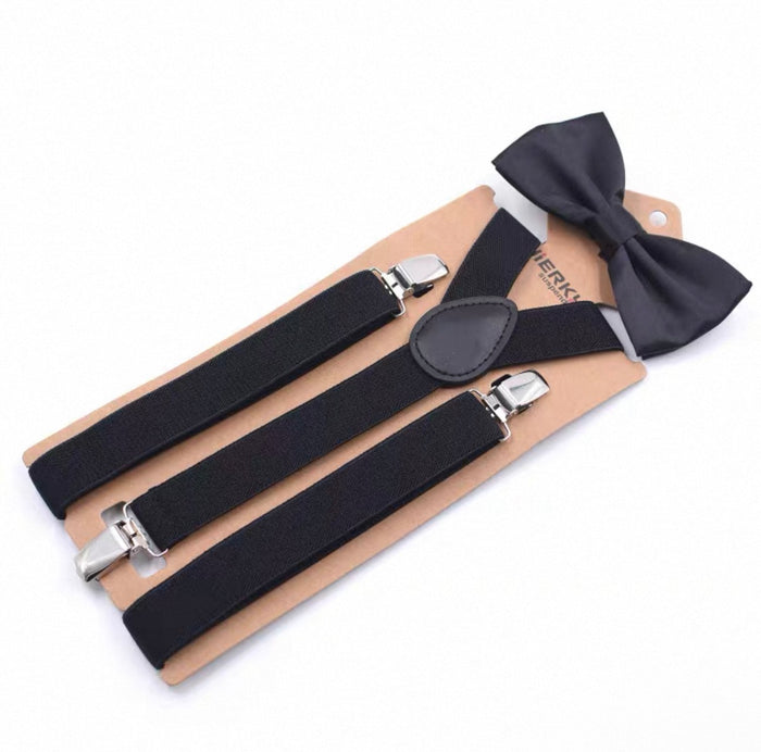 Black suspenders and bow tie set on a beige card with visible brand name.