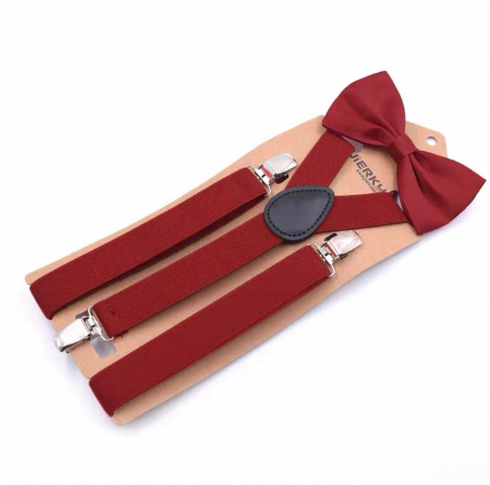 Red suspenders and bow tie set on a beige card with visible brand name.