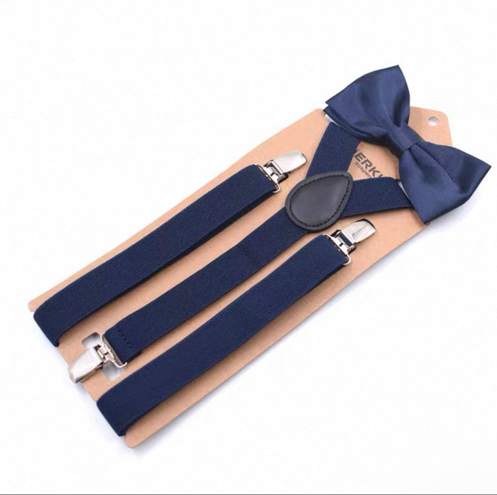 Navy blue suspenders and bow tie set on a beige card with visible brand name.