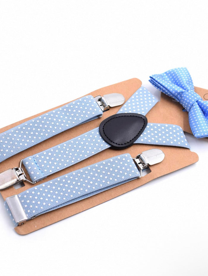 Blue polka dot suspenders and bow tie set on a white background