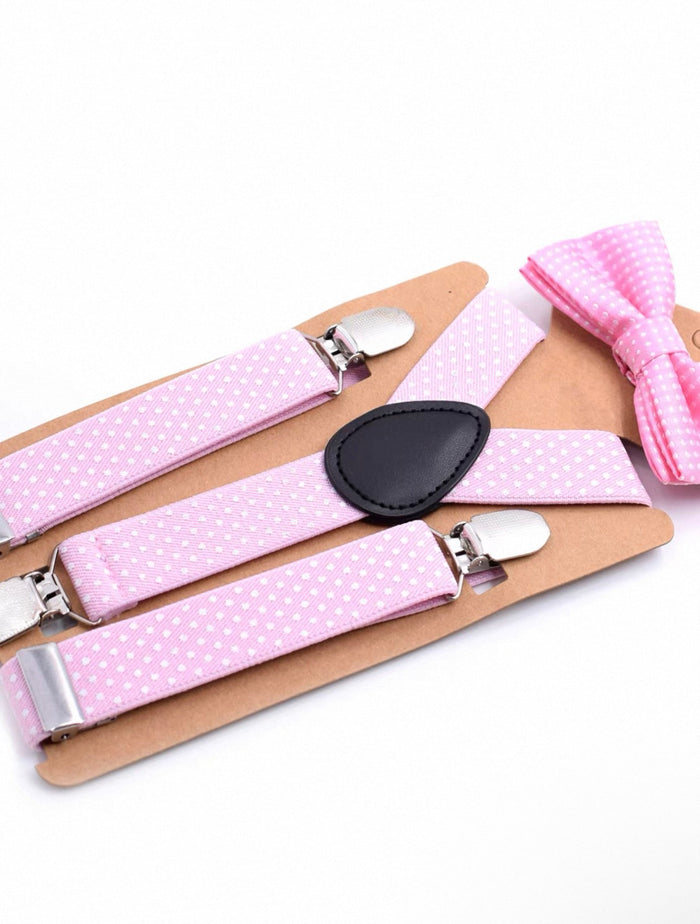 Pink polka dot suspenders and bow tie set on a white background
