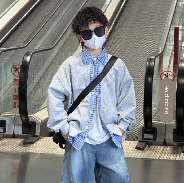 Person wearing a face mask and sunglasses in an indoor setting with escalators.