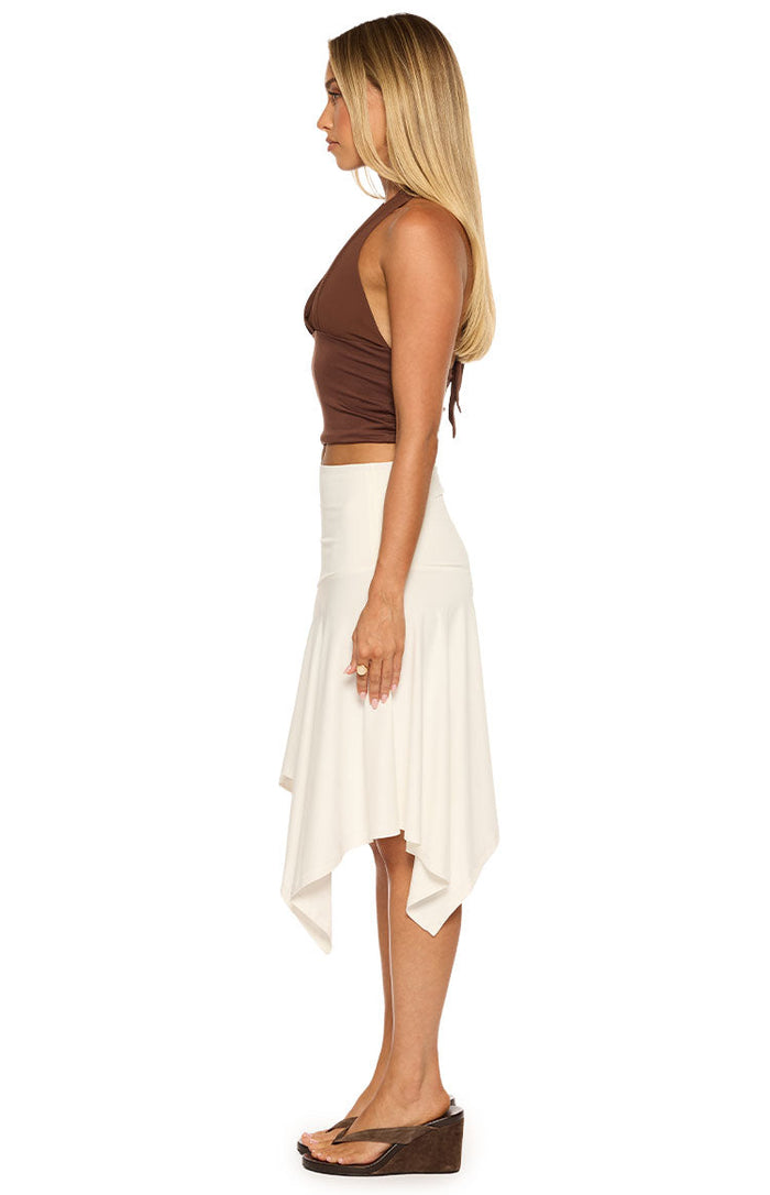 Side view of a white asymmetrical midi skirt with a draped pointed hem