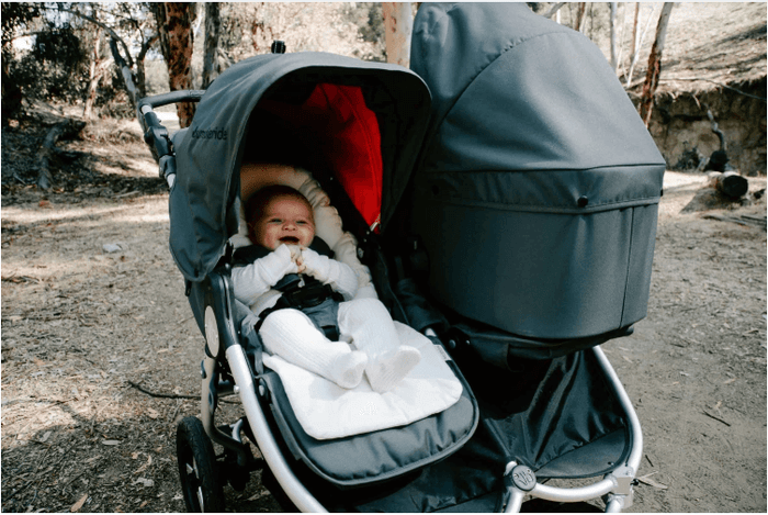 Double stroller with baby using Bumbleride Organic Cotton Infant Insert for comfy rides