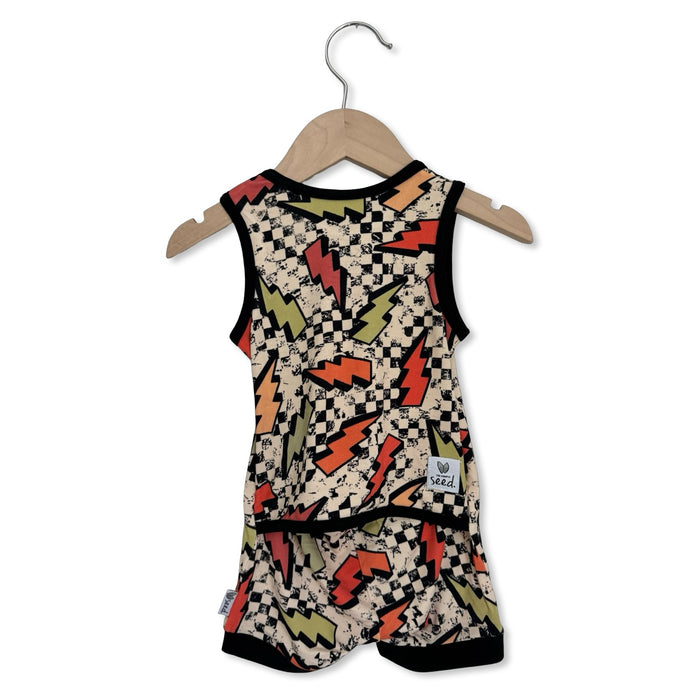 Baby romper with checkered and lightning bolt pattern on a hanger against a white background