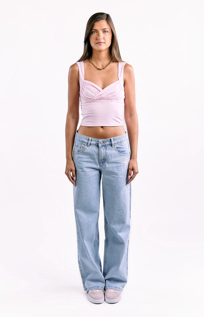 Light wash low waist baggy leg jeans with a subtle white star embroidery on the right front pocket