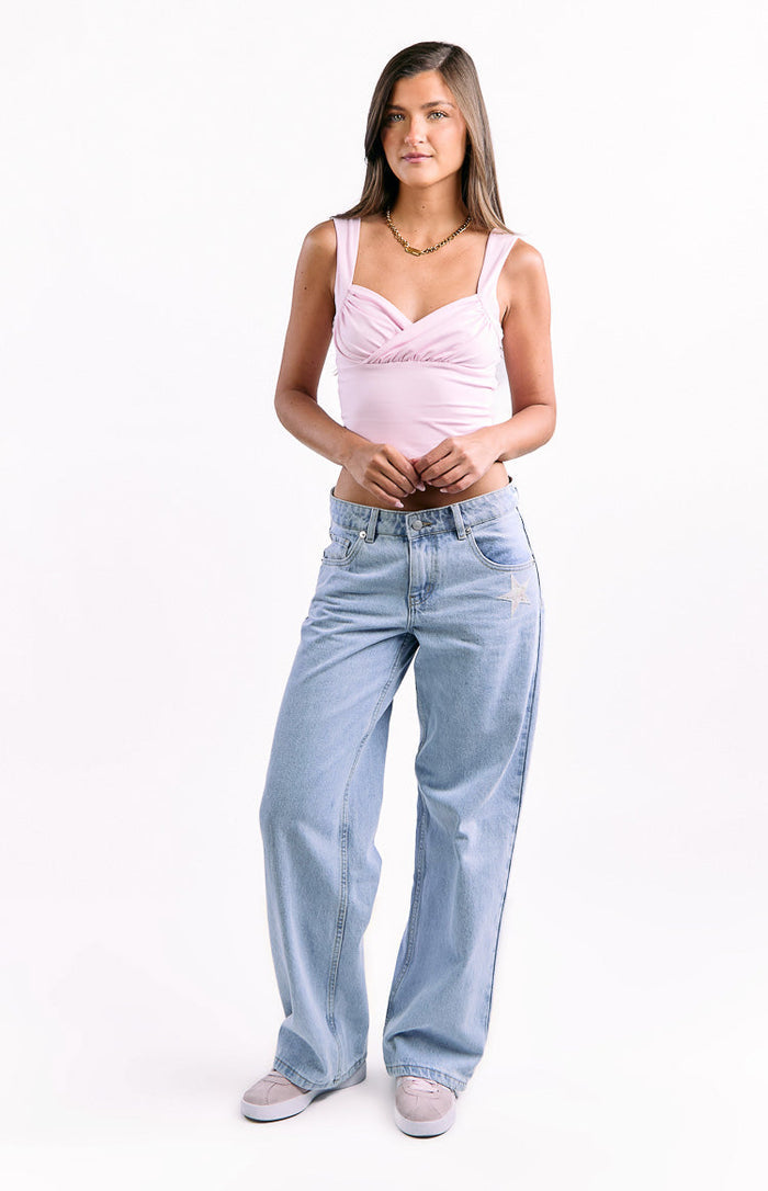 Light wash low waist baggy leg jeans with a star embroidery detail on the right thigh