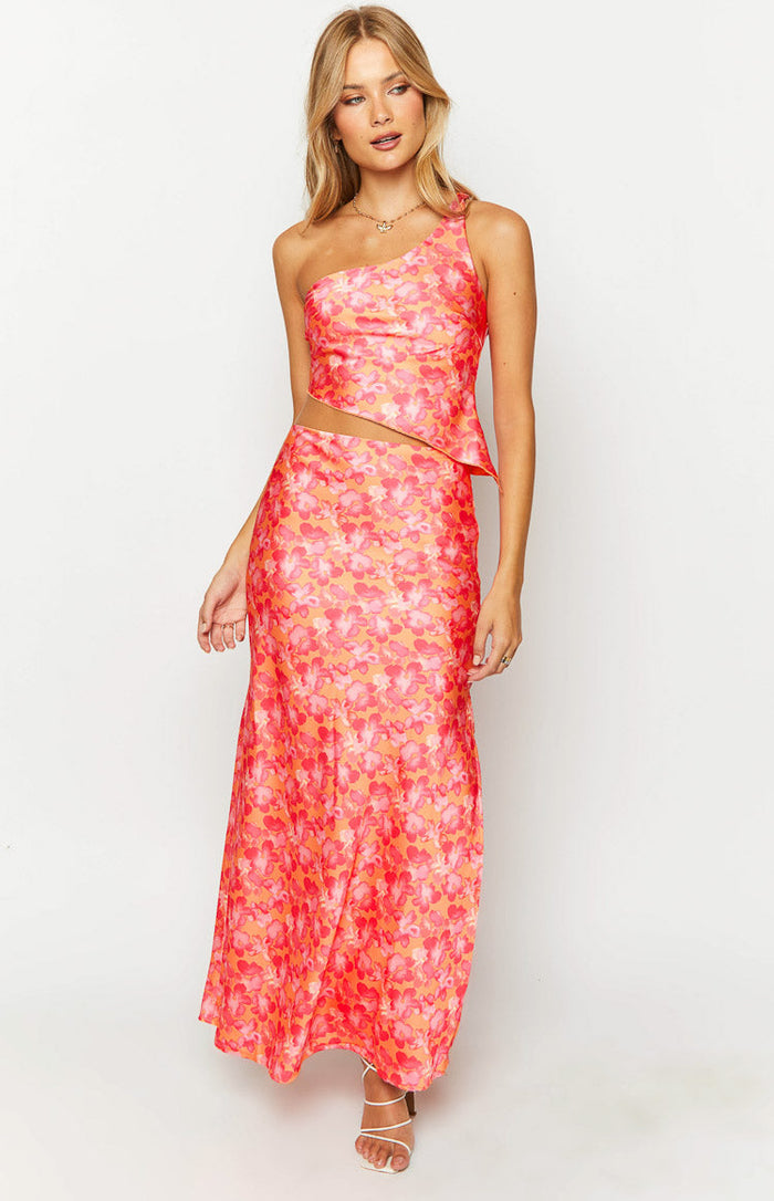 Front view of an orange and pink floral satin one shoulder top with an asymmetric cropped hem