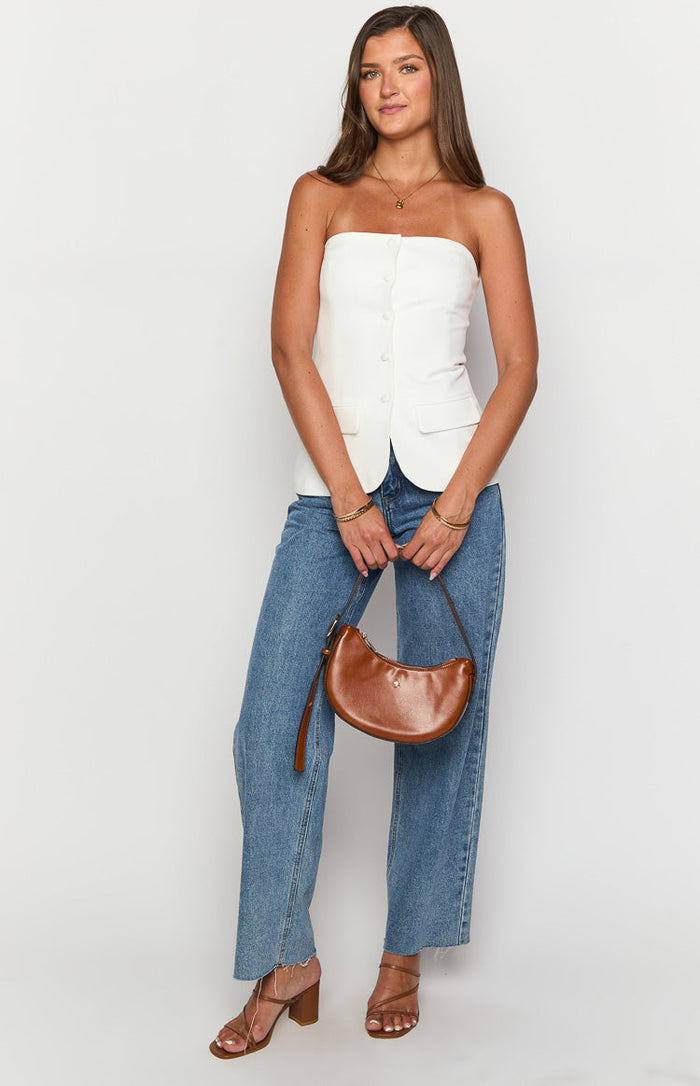 White strapless button-up top with a fitted vest-style cut and front flap pockets