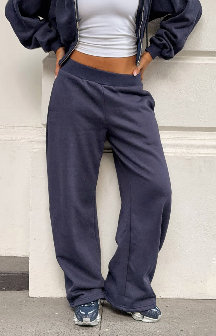 Beginning Boutique Dora Navy Barrel Leg Track Pants navy fleece barrel leg track pants with a ribbed waistband and side pocke