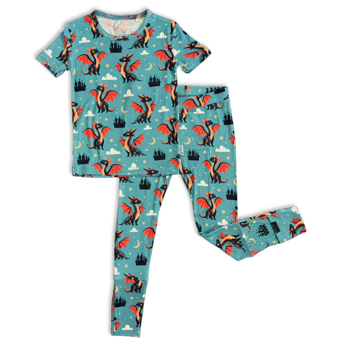 Children's pajama set with dragon pattern on a blue background
