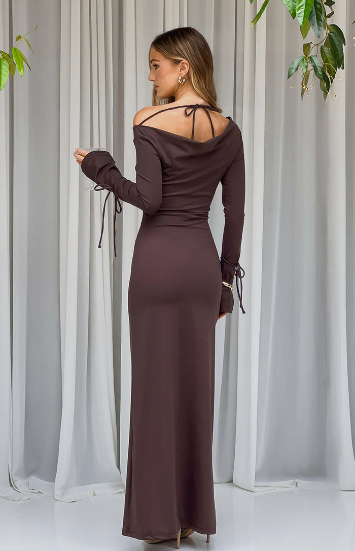 Rear view of a chocolate jersey maxi dress with a cowl back, tie-up spaghetti straps, and long sleeves with tie cuffs