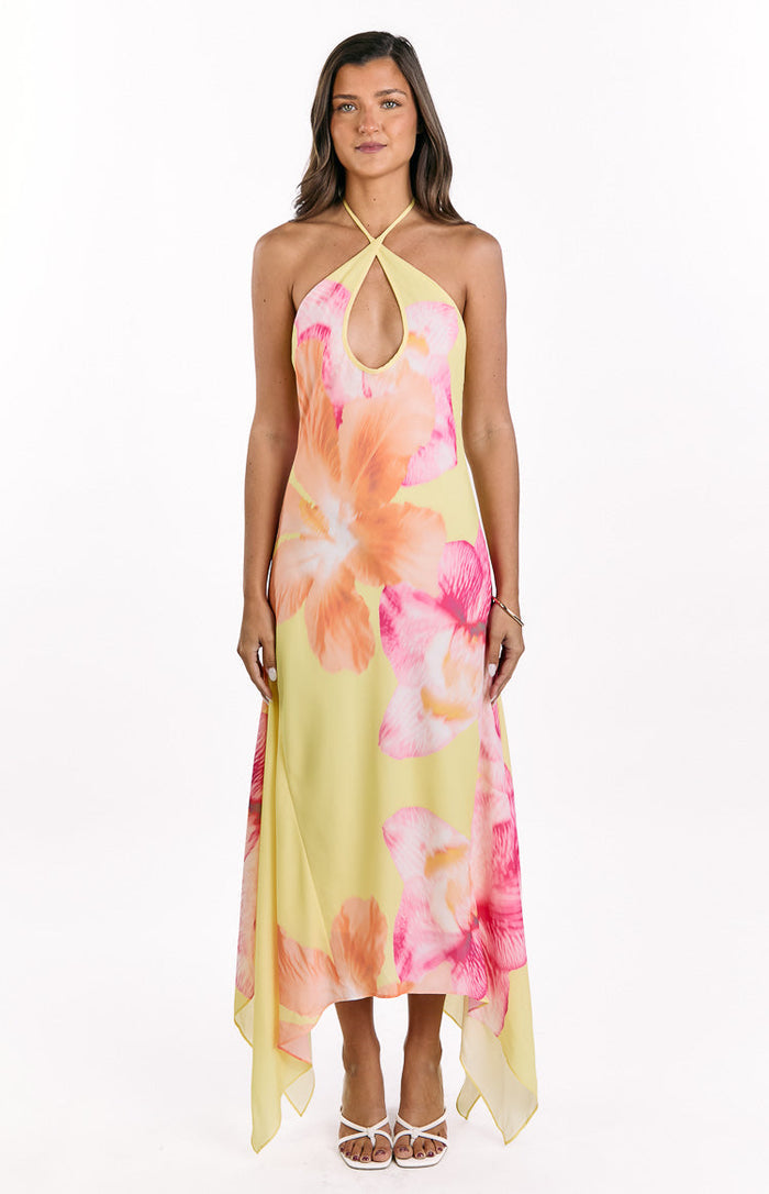 Flowy yellow hibiscus floral maxi dress with a halter neckline and asymmetric handkerchief hem