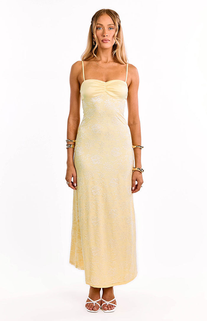 Full length front view of a yellow lace maxi dress with spaghetti straps and a ruched bust