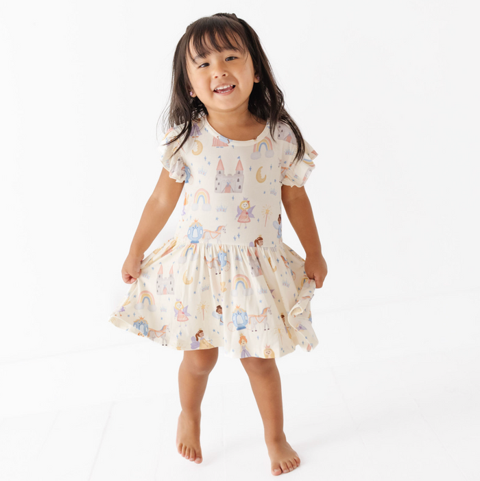 Young girl wearing a patterned dress on a white background