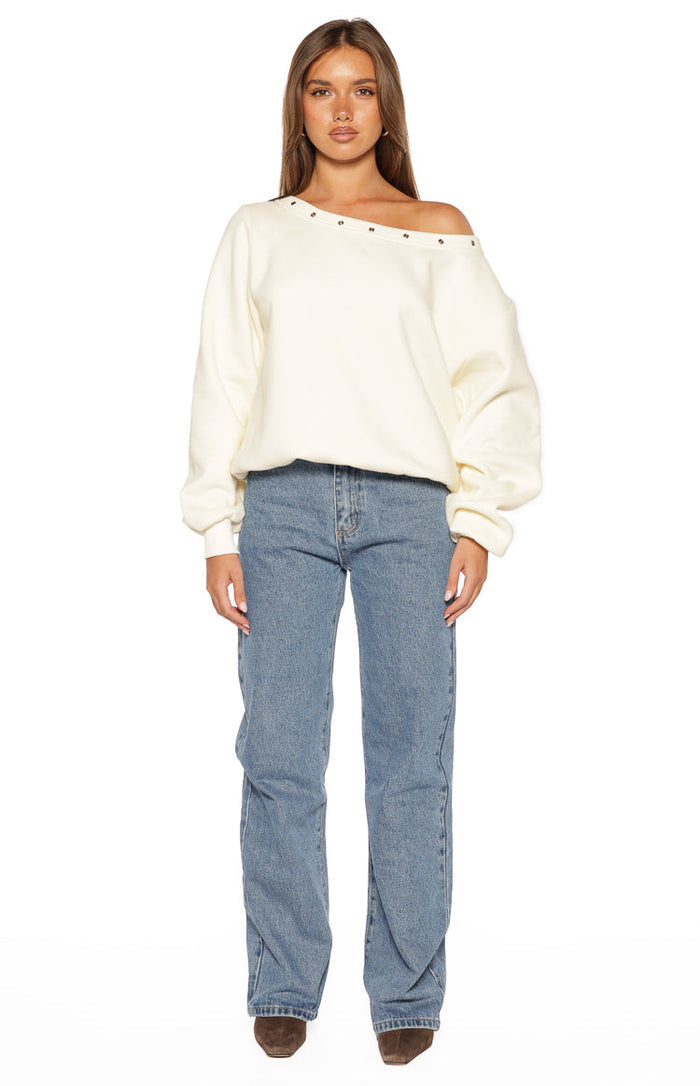 Front view of mid wash denim jeans with a relaxed straight-leg fit and classic five-pocket styling