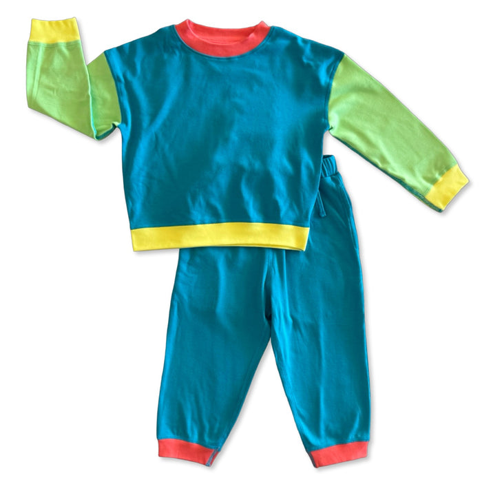 Colorful children's outfit with green sleeves, red collar, yellow waistband, and blue pants on a white background.