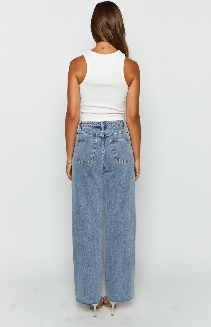Rear view of light blue wide-leg denim jeans with back pockets and a high-waisted fit