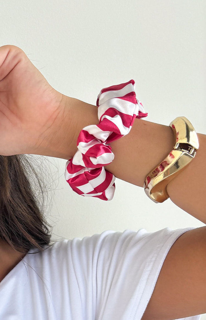 Red and white striped satin scrunchie with a gathered, ruffled texture