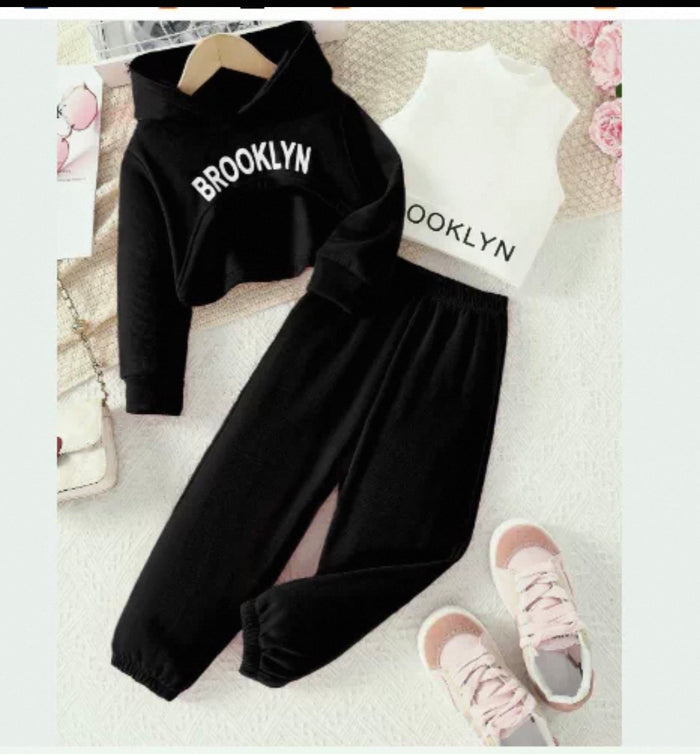Black 'Brooklyn' sweatshirt and pants set with pink shoes on a floral background