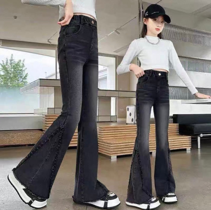 Two people wearing black flared jeans in an indoor setting.